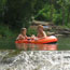 Children in tubes floating in the creek