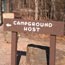 wooden campground host sign with arrow