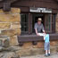 Stone building with Ranger talking to a boy through a window