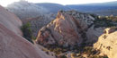 Photo of tilted rock layers at sunrise.