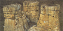 Three, massive petrified stumps of redwood trees over 10 feet tall