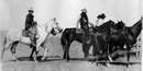 Cowboys on horseback on the open range.