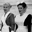 2 Harvey Girls in black and white uniforms