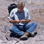 looking at a fossil in the field