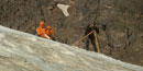 a photo of a man measuring a glacier using a theodolite