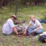 Archeologists digging a test pit