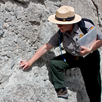 A ranger points out a fossil on the Fossil Discovery Trail