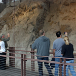 Visitors gaze at the dinosaur bones exposed in the Carnegie Quarry