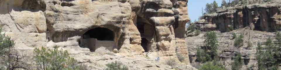 Visitors hike along the base of the Gila Cliff Dwellings.