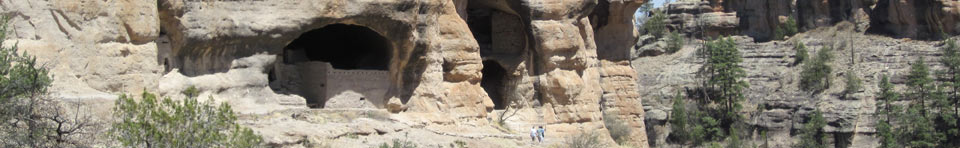Visitors hike along the base of the Gila Cliff Dwellings.