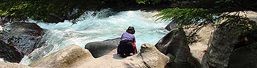 A visitor too close to frigid, fast moving water