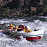 Colorful dory running a rapid in Grand Canyon National Park. NPS photo by Bob Butterfield.