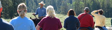 A concession wrangler speaking to visitors