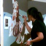Ayako Sami paints a mural featuring Guadalupe Mountains National Park