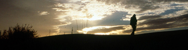 Hiker on the Salt Basin Dunes at sunset.