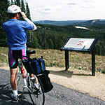 A bicyclist takes in the view from atop Mt. Washburn