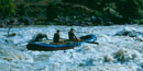 Raft going through rapids. Raft going through rapids.