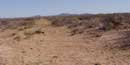 Traces of a dirt road, El Camino Real de Tierra Adentro, stretch across a southern New Mexico desert landscape Traces of a dirt road, El Camino Real de Tierra Adentro, stretch across a southern New Mexico desert landscape