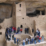 Visitors encircle a kiva at Cliff Palace