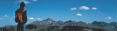 a photo of a hiker with Longs Peak in the background