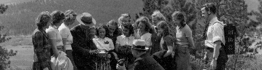 A photo of rangers talking to kids in the 1940s.