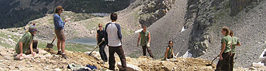 A photo of researchers digging for glacier ice.