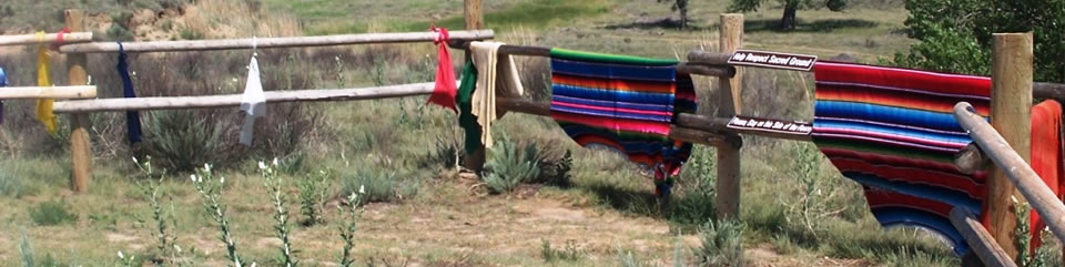 Blankets, hides, and other offerings hang at massacre overlook
