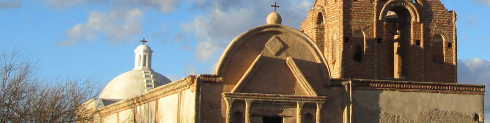 Sunlight illuminates the top of historic Mission San José de Tumacácori church.