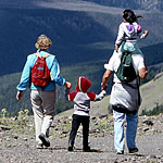 A family takes in the view from the top of 10,000-foot Mt. Washburn.
