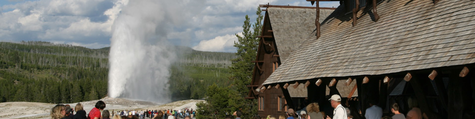 Visitors enjoy an eruption of Old Faithful from the Inn.