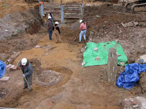 Photo of Archeologists clearing rubble and fill deposits from historic surfaces at the James Dexter site