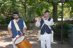 Costumed actors performing near Second Bank