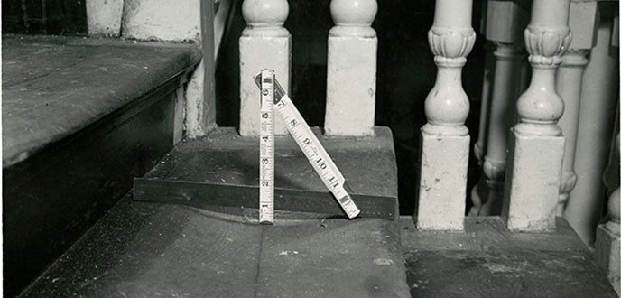 Photograph of stair tread in Independence Hall's staircase with ruler showing the degree of wear caused by visitors' feet.