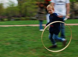 Budding Junior Ranger playing at rolling hoop near the Liberty Bell Center on Junior Ranger Day.