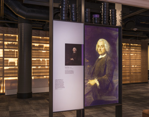 Interior view of the Benjamin Franklin Museum showing an exhibit panel featuring Franklin's image.
