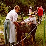 A volunteer demonstrates clothes washing during Duneland Harvest Festival.