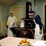 Cooks by a wood burning stove at Chellberg Farm