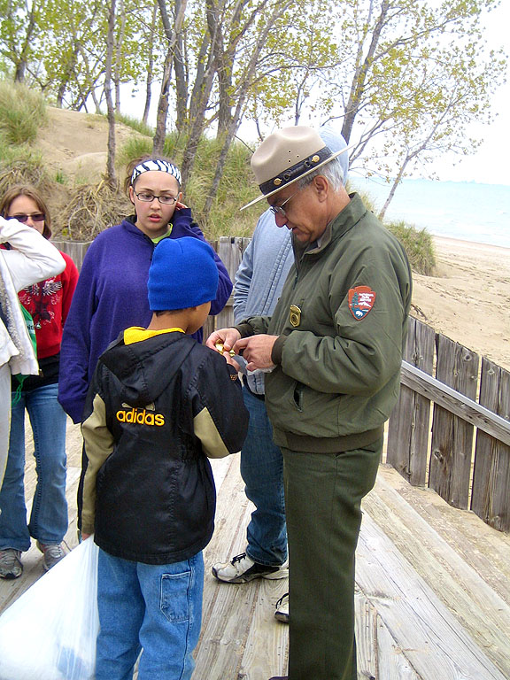 Park Superintendent, Costa Dillon, awards one of the first Great Lakes junior ranger badges.