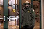 Park Ranger opening glass door to a building