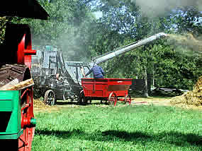 large machine, powered by a long belt, with a straw comming from a 10 foot long tube that projects out/up from the back of the machine.