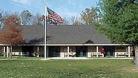building with grass in the front and the American flag flying above the roof