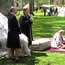 people dress in late 1700's clothing in a camp setting