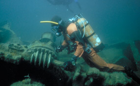 Diver examines shipwreck Diver examines shipwreck