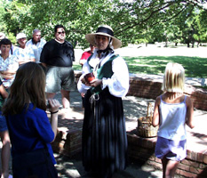 Living History character Joan Pierce speaking to visitors about life in 17th century Virginia