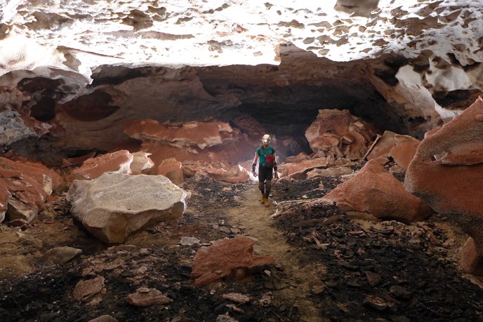 A caver explores a large passage in Jewel Cave.