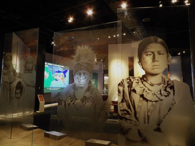 large images of American Indian woman and man with computer interactive visible behind