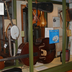 Cajun music exhibit with banjo, bass, accordion, and other instruments