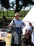 Women in 1815 dress demonstrate campfire cooking
