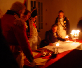British officers in 1815 uniforms plot strategy around a table