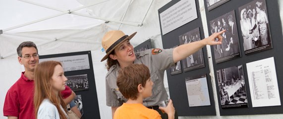 A ranger interpreting images for two children visitors
